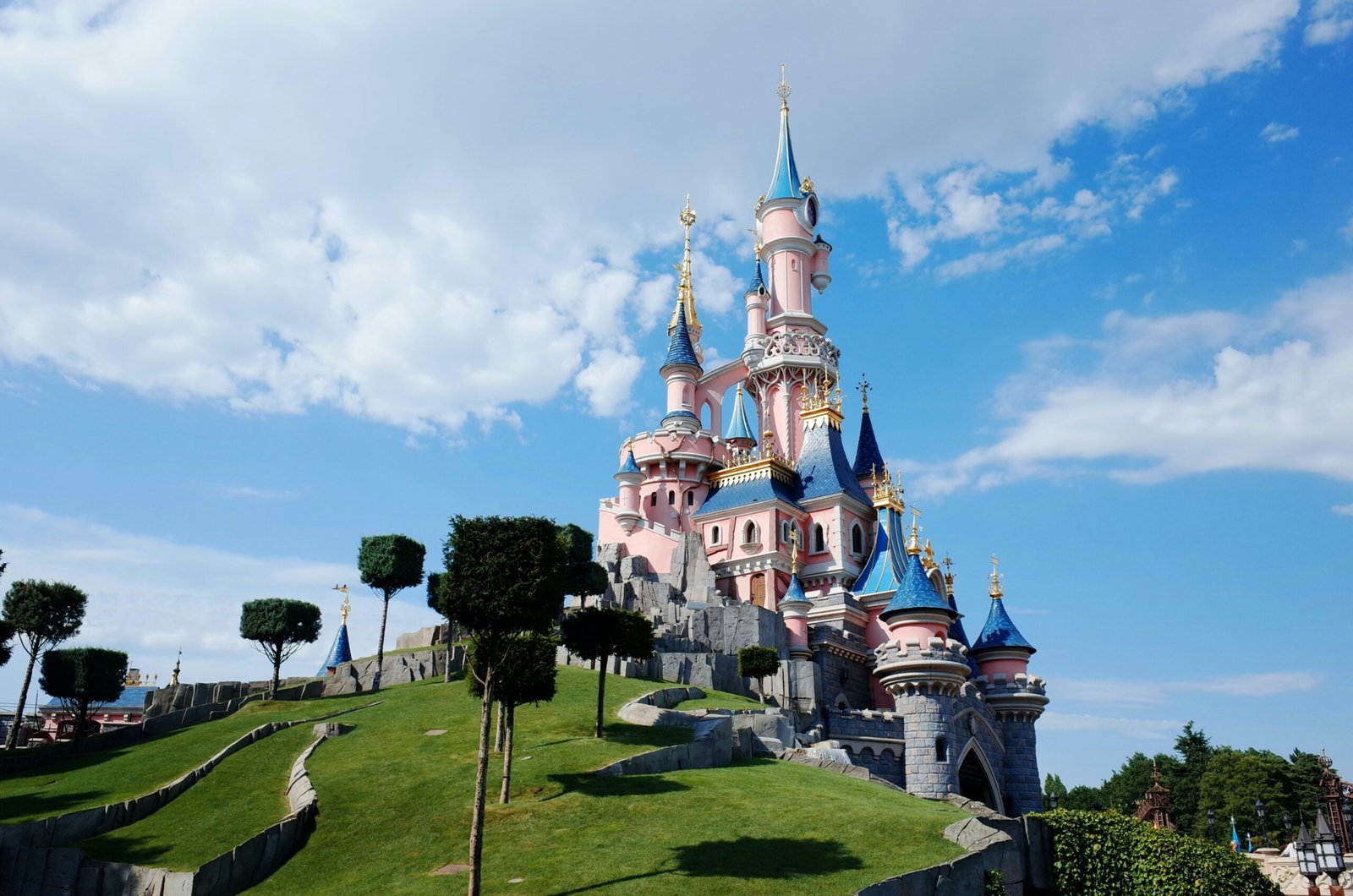 white and blue castle under white clouds and blue sky during daytime